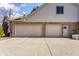 Three-car garage with white doors and ample driveway space for parking at 7411 Perrier Dr, Indianapolis, IN 46278