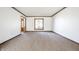 Large living room with neutral carpet, white walls, and trim at 7411 Perrier Dr, Indianapolis, IN 46278