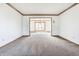 Large living room with neutral carpet, white walls, and natural light at 7411 Perrier Dr, Indianapolis, IN 46278