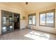 Sunroom offers sliding doors, neutral tile flooring and multiple large windows overlooking the backyard at 7411 Perrier Dr, Indianapolis, IN 46278