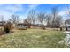 Spacious backyard with a trampoline, lawn, and a partial fence surrounding the property at 803 Hickory Way, Noblesville, IN 46062