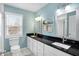 Stylish bathroom with double sinks, black countertop, and light blue walls at 803 Hickory Way, Noblesville, IN 46062