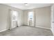 Bright bedroom with neutral walls, carpet and white curtains at 803 Hickory Way, Noblesville, IN 46062