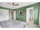 Bedroom with green walls, ceiling fan and attached bathroom at 803 Hickory Way, Noblesville, IN 46062