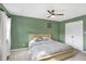 Bedroom with green walls, ceiling fan and built in closet at 803 Hickory Way, Noblesville, IN 46062