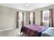Bright bedroom with three windows, neutral walls, carpet and gray curtains at 803 Hickory Way, Noblesville, IN 46062