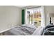 Cozy bedroom featuring sliding glass door and decorative green shutter detail at 803 Hickory Way, Noblesville, IN 46062