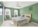 Bedroom with green walls, ceiling fan and two windows at 803 Hickory Way, Noblesville, IN 46062