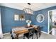 Charming dining room features blue walls, a rustic table, and plenty of natural light at 803 Hickory Way, Noblesville, IN 46062