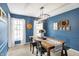 Charming dining room features blue walls, a rustic table, and plenty of natural light at 803 Hickory Way, Noblesville, IN 46062