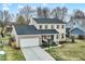 Two-story home with a two-car garage, an inviting front porch, and a basketball hoop at 803 Hickory Way, Noblesville, IN 46062