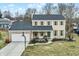 Two-story home with a two car garage, well manicured lawn, and an inviting front porch at 803 Hickory Way, Noblesville, IN 46062