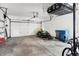 Spacious garage with overhead storage, lawn mower, and access to the exterior at 803 Hickory Way, Noblesville, IN 46062