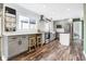 Modern eat-in kitchen featuring grey cabinets, stainless appliances, and wood-look floors at 803 Hickory Way, Noblesville, IN 46062