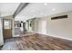 Open-concept living room featuring hardwood floors and a kitchen view at 803 Hickory Way, Noblesville, IN 46062