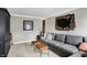 Comfortable living room featuring a cozy gray sofa and neutral colored walls at 803 Hickory Way, Noblesville, IN 46062