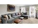 Comfortable living room featuring a cozy gray sofa and neutral colored walls at 803 Hickory Way, Noblesville, IN 46062