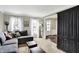 Cozy living room features a comfortable couch, plush carpet, and bright natural light at 803 Hickory Way, Noblesville, IN 46062