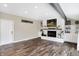 Cozy living room with a white brick fireplace and hardwood floors at 803 Hickory Way, Noblesville, IN 46062