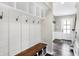 Mudroom with white wainscoting, wood bench, and built-in shelving at 803 Hickory Way, Noblesville, IN 46062