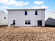 Exterior rear view of the property featuring a grassy yard, window views, and sliding glass door at 8310 Bearberry Ln, Pendleton, IN 46064