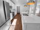 Open kitchen with modern appliances, a bright sink, and light wood flooring at 8310 Bearberry Ln, Pendleton, IN 46064
