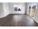 Bright living room features wood-look floors, a window and sliding glass door that fills the room with light at 8310 Bearberry Ln, Pendleton, IN 46064