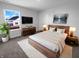 Well-lit main bedroom with a plush rug, modern furniture, and a picturesque window view at 8310 Bearberry Ln, Pendleton, IN 46064