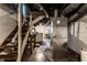 This is an unfinished basement with a furnace and stairs at 85 N Dearborn St, Indianapolis, IN 46201