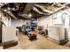 Unfinished basement with exposed ductwork and concrete floor houses laundry appliances at 85 N Dearborn St, Indianapolis, IN 46201