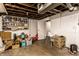 Unfinished basement with white painted walls, storage shelves and a closed door at 85 N Dearborn St, Indianapolis, IN 46201