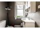 This is a half bathroom featuring a sink, toilet, and frosted window at 85 N Dearborn St, Indianapolis, IN 46201