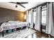 This bedroom boasts a ceiling fan, many windows and hardwood flooring at 85 N Dearborn St, Indianapolis, IN 46201
