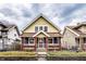Charming two-story home with yellow and blue siding, brick accents, and a well-maintained front yard at 85 N Dearborn St, Indianapolis, IN 46201