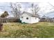 View of white detached garage in the fenced backyard with small lawn at 85 N Dearborn St, Indianapolis, IN 46201