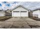 Double door detached white garage with concrete driveway and cloudy sky at 85 N Dearborn St, Indianapolis, IN 46201