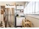 This kitchen features a stainless steel refrigerator and white cabinetry above black and white checkered floors at 85 N Dearborn St, Indianapolis, IN 46201