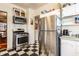 Functional kitchen with stainless steel appliances, black and white floors, and ample cabinet space at 85 N Dearborn St, Indianapolis, IN 46201