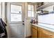 This kitchen features a back door, window, light wood cabinets, and white appliances at 85 N Dearborn St, Indianapolis, IN 46201