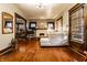 Spacious living room with hardwood floors, neutral paint, a fireplace, and natural light at 85 N Dearborn St, Indianapolis, IN 46201