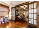 Living room featuring beautiful wood trim, hardwood floors, and view to dining room with furniture at 85 N Dearborn St, Indianapolis, IN 46201