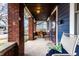 Relaxing outdoor porch space featuring brick columns, a chair, string lights, and view to the neighborhood at 85 N Dearborn St, Indianapolis, IN 46201