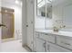 Bathroom featuring white cabinets and a sink with gold fixtures and a shower at 8751 Jaffa Court E Dr # 17, Indianapolis, IN 46260