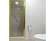 Close-up of a shower with gold trim and a toilet in the bathroom at 8751 Jaffa Court E Dr # 17, Indianapolis, IN 46260