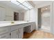 Bathroom vanity featuring dual sinks, gold fixtures and a large mirror at 8751 Jaffa Court E Dr # 17, Indianapolis, IN 46260