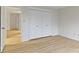 Bright bedroom featuring a closet with white doors and light wood floors at 8751 Jaffa Court E Dr # 17, Indianapolis, IN 46260