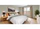 Well-lit main bedroom featuring a large bed, modern lamps, and a bright window view at 8751 Jaffa Court E Dr # 17, Indianapolis, IN 46260