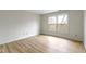 Bright bedroom featuring neutral walls, wood floors, and a bright window view at 8751 Jaffa Court E Dr # 17, Indianapolis, IN 46260