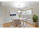 Cozy dining area featuring a round table, modern lighting, and a view of the outdoors at 8751 Jaffa Court E Dr # 17, Indianapolis, IN 46260
