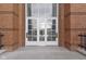 Close up of front doors to the building, featuring glass panels and brick surround at 8751 Jaffa Court E Dr # 17, Indianapolis, IN 46260